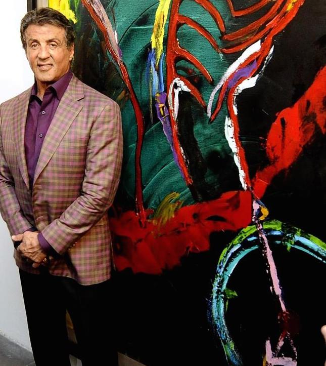 Stallone poses with one of his paintings